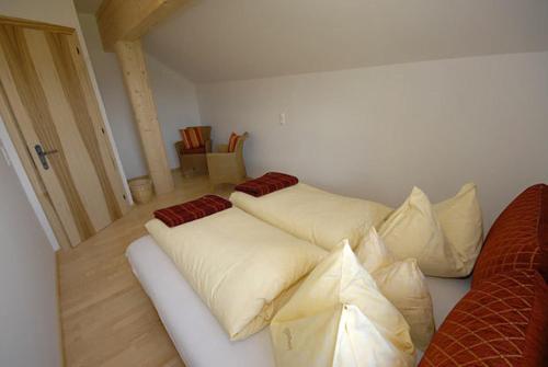 two pillows on a couch in a room at Appartements Stiererhof in Ramsau am Dachstein