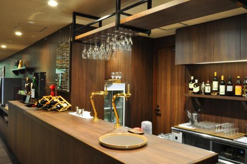 a bar with a counter with bottles of wine at Hachimantai Mountain Hotel & Spa in Hachimantai
