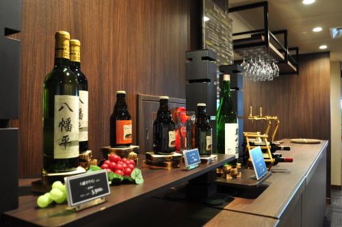 a bar with bottles of wine on a counter at Hachimantai Mountain Hotel & Spa in Hachimantai