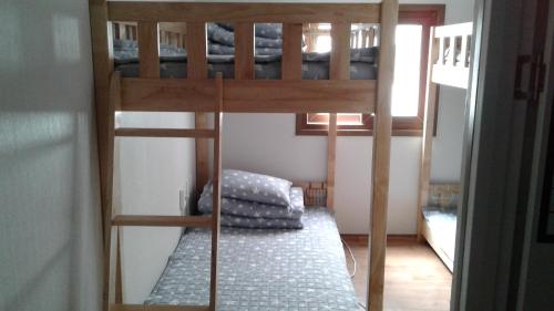 a couple of bunk beds in a room at Friends of Loft in Tongyeong
