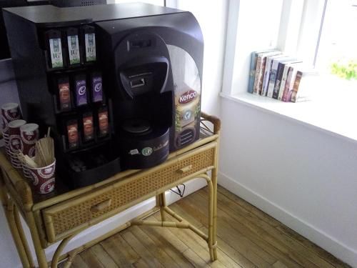 a coffee machine sitting on a stand next to a window at Starfish Rooms in Tarbert