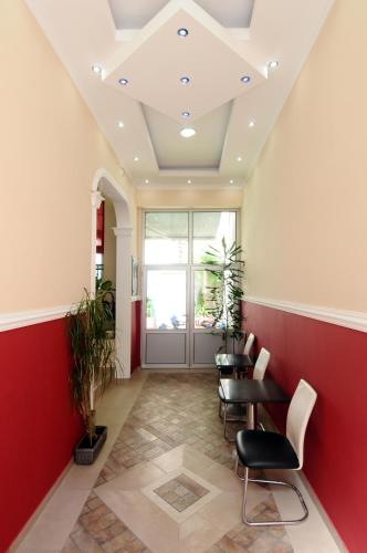 a room with red and white walls and tables and chairs at Villa Forever in Belgrade