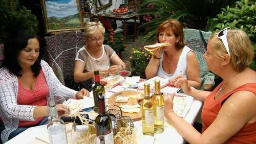 a group of women sitting at a table eating food at Fónagy és Walter Vendég- és Borház in Vác