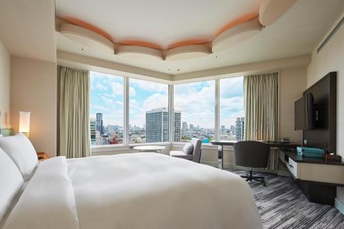 a hotel room with a large bed and a large window at The Prince Park Tower Tokyo - Preferred Hotels & Resorts, LVX Collection in Tokyo