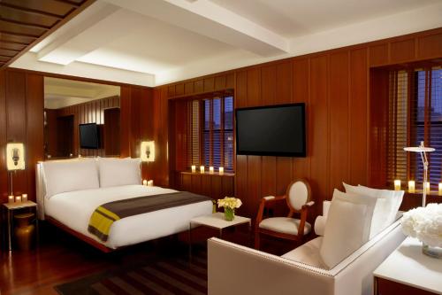 a hotel room with a bed and a tv at Hudson New York in New York
