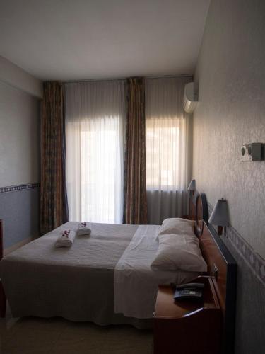 a bedroom with a large bed and a window at Hotel Kroma in Ragusa