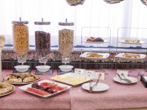 a table with many plates of food on it at Hotel Kroma in Ragusa