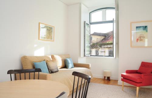 a living room with a couch and a red chair at Lisbon Serviced Apartments - Baixa Castelo in Lisbon