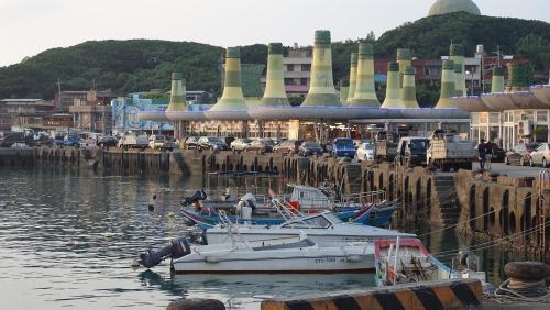 a boat is docked in the water in a harbor at Emoonten Homestay in Sanzhi