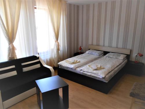 a small bedroom with a bed and a window at Guest House Tsenovi in Koprivshtitsa