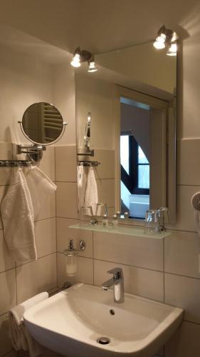 a bathroom with a sink and a mirror at Hotel Fürstenberger Hof in Xanten