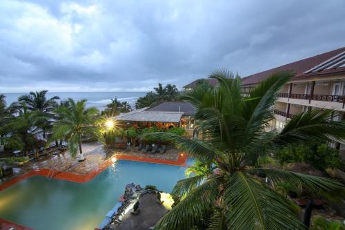 an aerial view of a resort with a pool and palm trees at Best Western Plus Accra Beach Hotel in Teshi