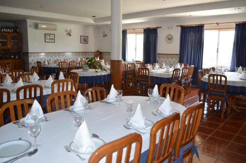 a dining room with tables and chairs with napkins on them at Hotel Marisol in Macedo de Cavaleiros
