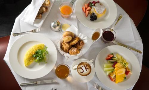 a white table with plates of food on it at J.K. Place Roma - The Leading Hotels of the World in Rome