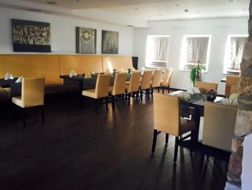 a dining room with a long table and chairs at Hotel Restaurant Jägerhof in Düren - Eifel