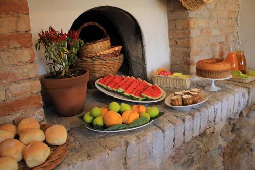 a buffet of fruits and vegetables on a stone counter at La Peschiera B&B in San Lorenzo del Vallo