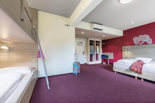a bedroom with two beds and an american flag at Serways Hotel Heiligenroth in Montabaur
