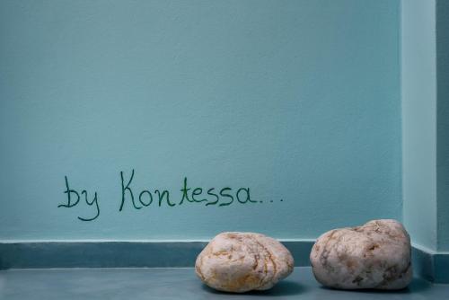 two cookies sitting on a table in front of a wall at Ios Resort in Ios Chora