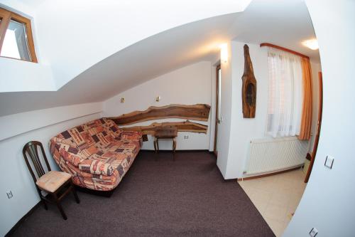 a living room with a couch and a table at Family Hotel Nadejda in Bansko