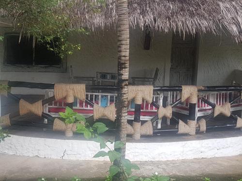 a porch of a resort with a table and chairs at Scorpio Villas Resort in Malindi