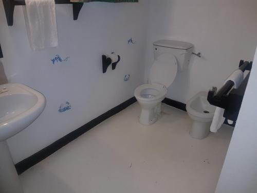 a bathroom with a toilet and a sink at Scorpio Villas Resort in Malindi