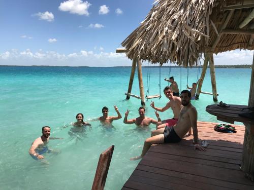 a group of people in the water in the ocean at Ecocamping Yaxche in Bacalar