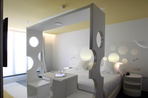 a hotel room with a large bed and a large mirror at Room Mate Pau in Barcelona