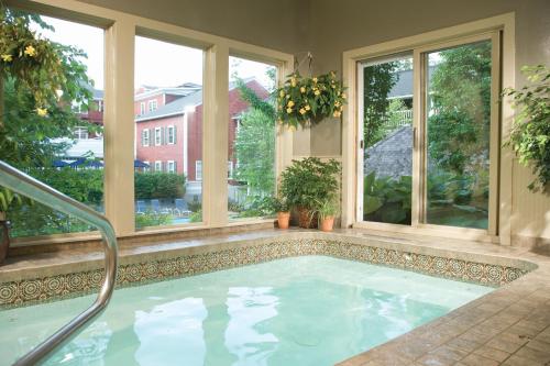 a large swimming pool in a house with windows at Green Mountain Inn in Stowe