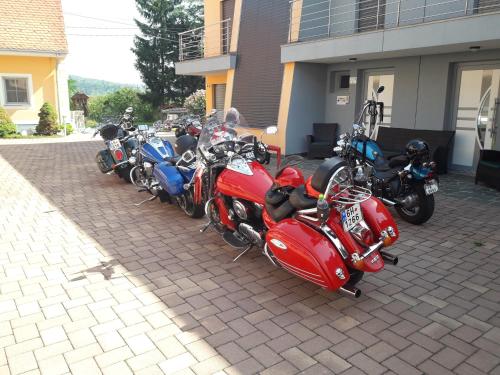 a row of motorcycles parked outside of a building at Apartments Akacijev Izvir in Miklavž na Dravskem Polju