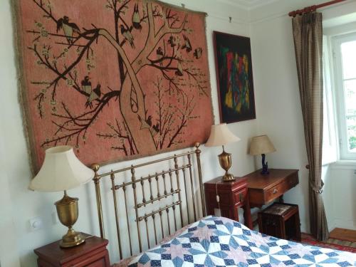 a bedroom with a bed and a painting on the wall at Morbey's Chalet in Sintra