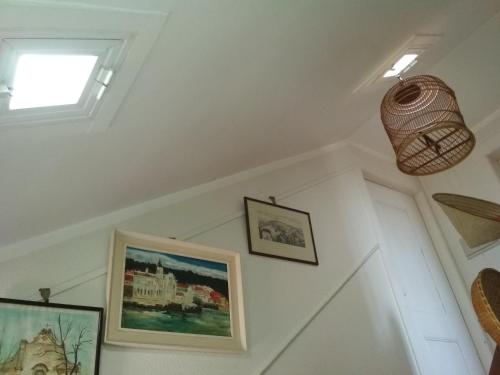 a room with two pictures on the wall and a window at Morbey's Chalet in Sintra