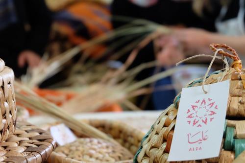 a display of baskets of food with a sign on it at Beit Al Baraka in Um Qeis