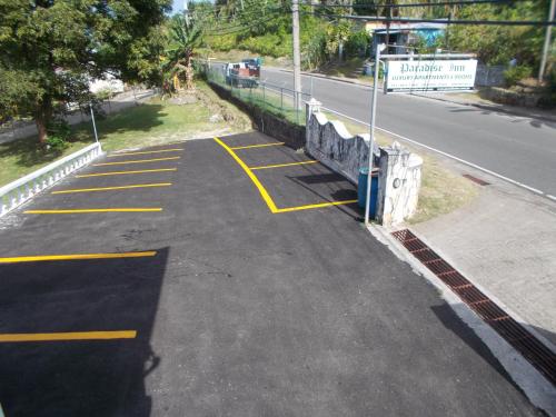 a parking lot with yellow lines on the side of a road at Paradise Inn in Port Antonio