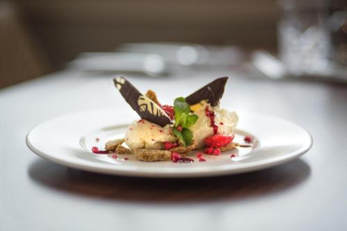 a white plate with a dessert on a table at Angels Hotel in Uddingston