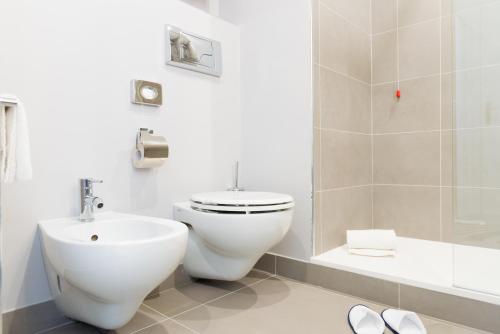 a bathroom with a toilet and a sink at Novotel Firenze Nord Aeroporto in Sesto Fiorentino