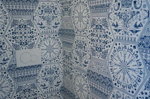 a group of blue and white vases on a wall at De Bedstee Boutique Capsules in Amsterdam