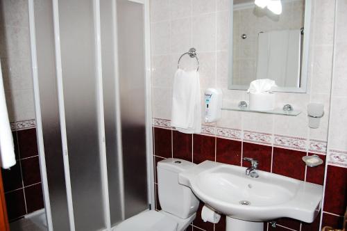a bathroom with a toilet and a sink at Triana Hotel in Antalya
