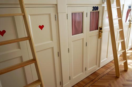 a room with white doors with red hearts on them at De Bedstee Boutique Capsules in Amsterdam