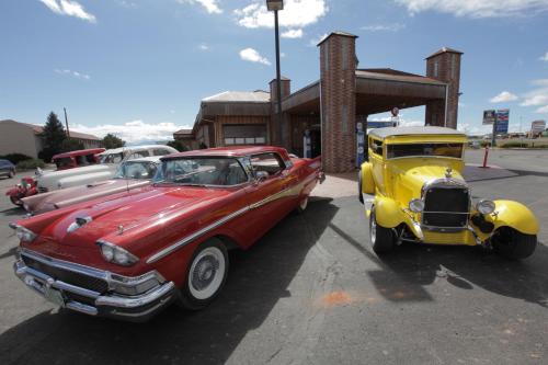 two old cars are parked in a parking lot at Grand Canyon Inn and Motel - South Rim Entrance in Valle