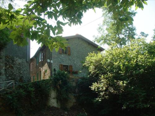 a stone building with trees in front of it at Casa Marta in Pescaglia