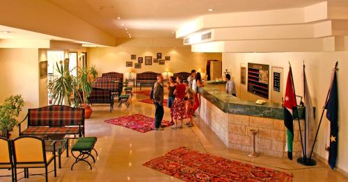 a group of people standing in a lobby at Petra Palace Hotel in Wadi Musa