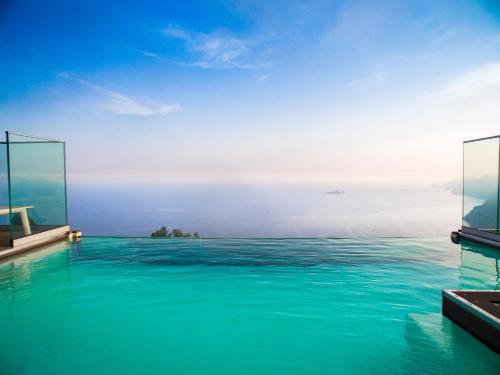 a swimming pool with a view of the ocean at Villa Degli Dei Luxury House in Positano