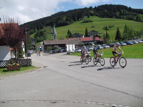 a group of people riding bikes down a street at Bed & Breakfast Jungholz - Pension Katharina in Jungholz