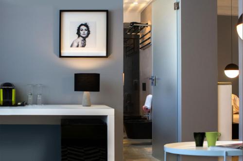 a living room with a fireplace and a picture on the wall at CinqueSuites Ortigia in Siracusa
