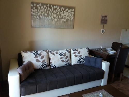 a couch in a living room with a table at Centar! Lara Zlatibor in Zlatibor