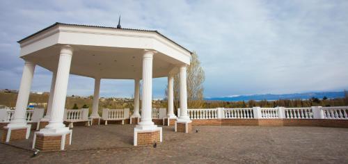 a white pavilion with chairs and a white fence at Lagos Del Calafate in El Calafate