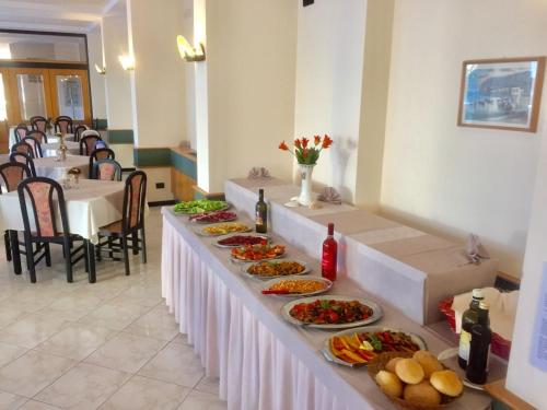 a row of tables with plates of food on them at Hotel Lido in Gargnano