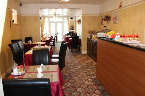 a restaurant with tables and chairs and a bar at The Homestar in Skegness