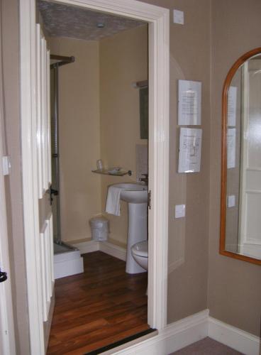 a bathroom with a toilet and a sink at The Kings Head Hotel in Abergavenny