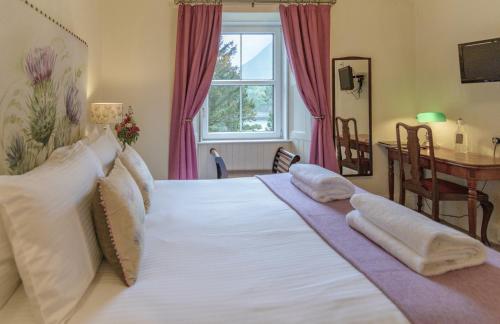 Tempat tidur dalam kamar di Loch Leven Hotel & Distillery
